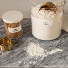 Load image into Gallery viewer, clear canisters with white lids holding baking supplies