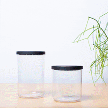 Load image into Gallery viewer, clear canister with black lid filling with pasta and being labeled