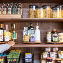 Load image into Gallery viewer, acacia wood turntable, lazy susan on pantry shelf holding oils and condiments