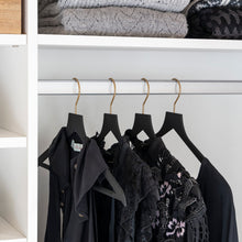 Load image into Gallery viewer, women&#39;s clothing closet with black slim, non-slip hangers and gold hooks holding tops
