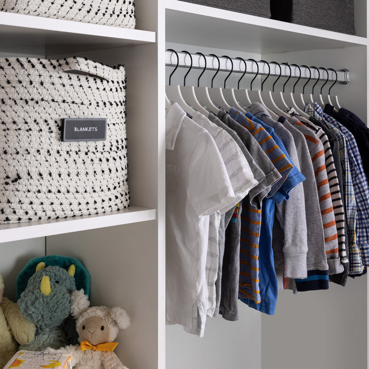boys' closet of white slim, non-slip hangers holding tops