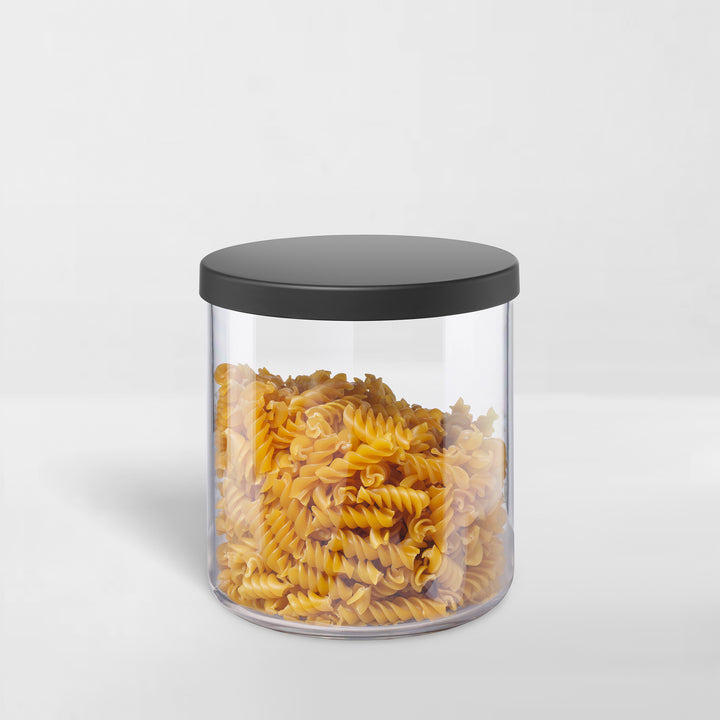 transparent storage canister with black lid holding pasta