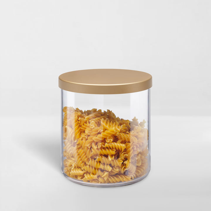 transparent storage canister with gold lid holding pasta