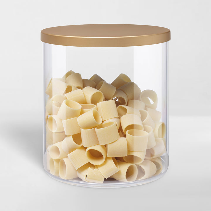 transparent storage canister with white lid holding pasta