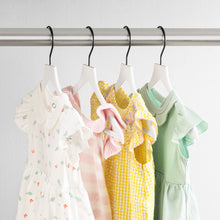 Load image into Gallery viewer, white slim, non-slip suit hangers with black hooks holding children&#39;s clothing
