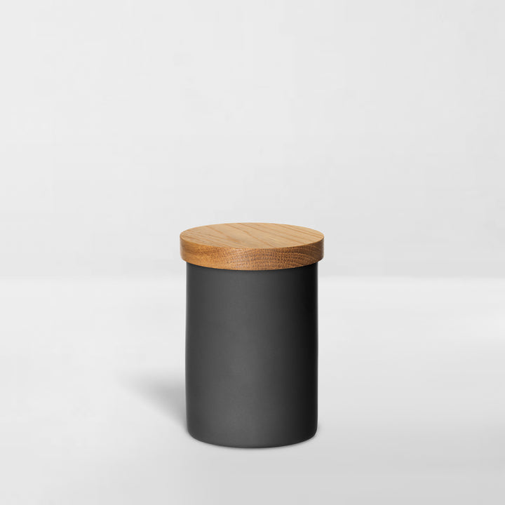 black ceramic jar with wood lid for organizing bathroom toiletries