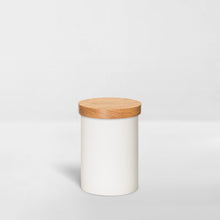 Load image into Gallery viewer, white ceramic jar with wood lid for organizing bathroom toiletries
