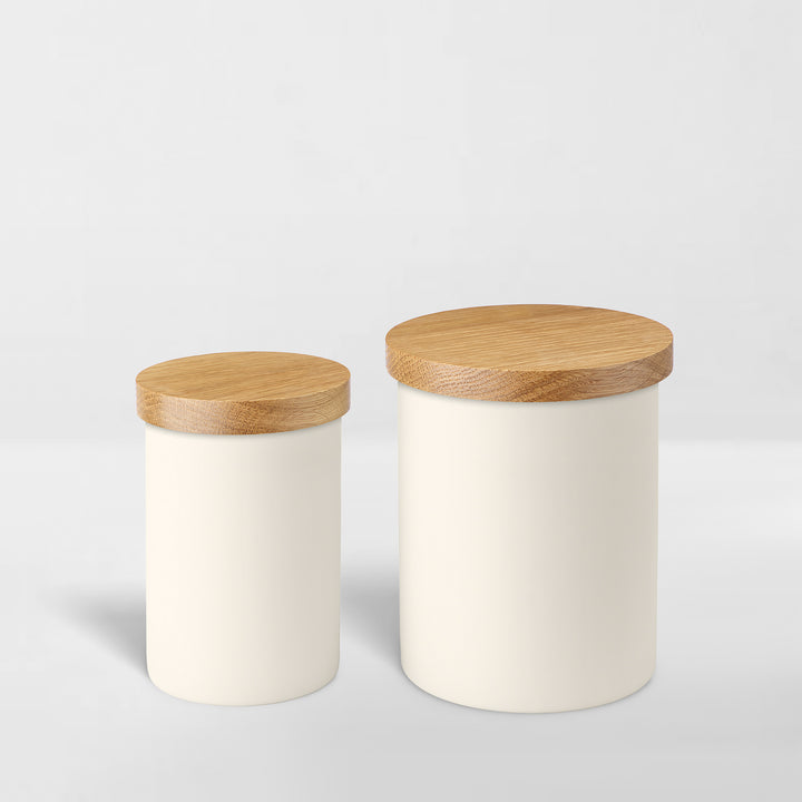 one small and one large white ceramic jar with wood lid for organizing 