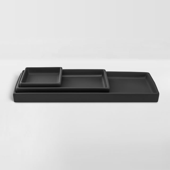 set of nested black ceramic trays for organizing