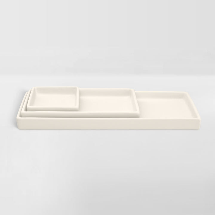 set of nested white ceramic trays for organizing