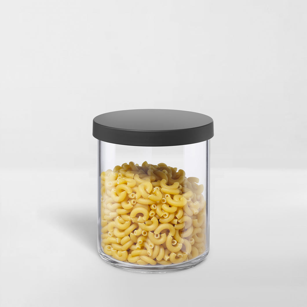 clear canister with black lid holding pasta