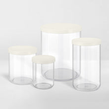 Load image into Gallery viewer, grouping of transparent storage canisters with white lids
