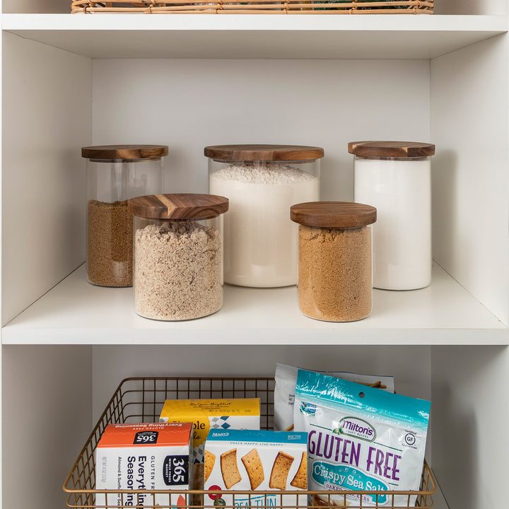 pantry shelf of glass jars with acacia wood lids holding baking supplies