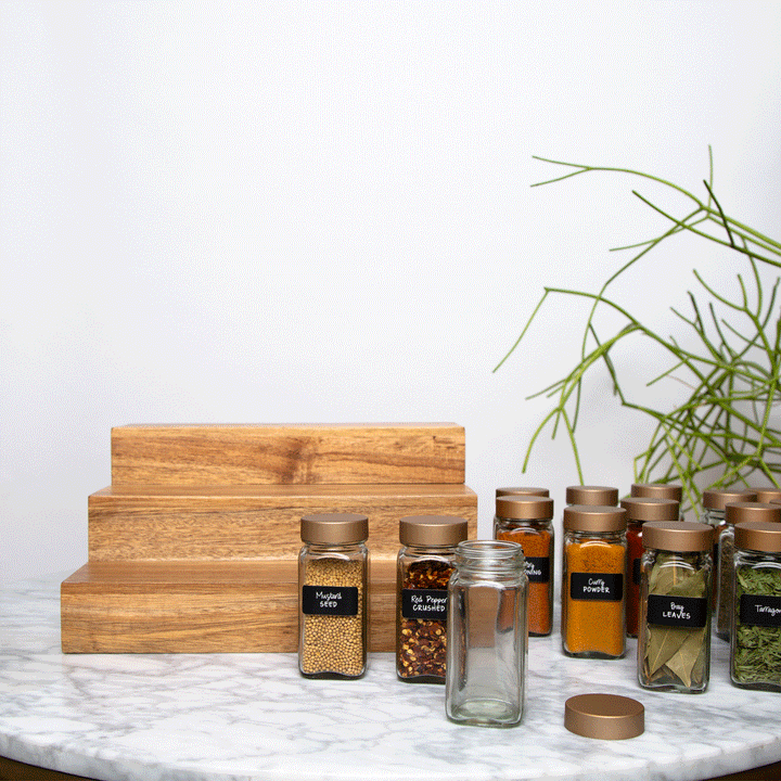 acacia wood expandable riser holding spice jars