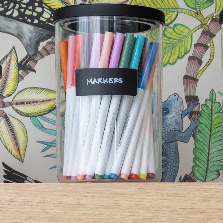 canister of markers on shelf with black removable label